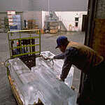 Workers unloading blocks of ice.