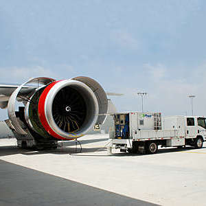 An EcoPower truck washing an airplane. 