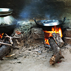 Pots simmering on a wood-burning mud stove.
