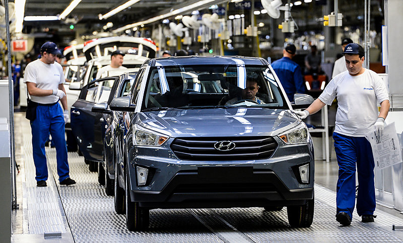 Hyundai workers checking cars.