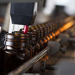 Bottles and pills on a pharmaceutical production line. 