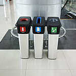 Colour-coded recycling bins inside an airport terminal.