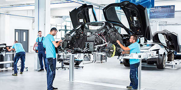 Two men from car manufacturers, working on the latest Concept-Two all-electric hyper car model.