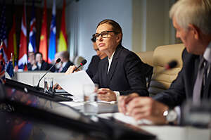 Female political deputy makes a speech at conference.