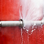 A leaking pipe on a red background.